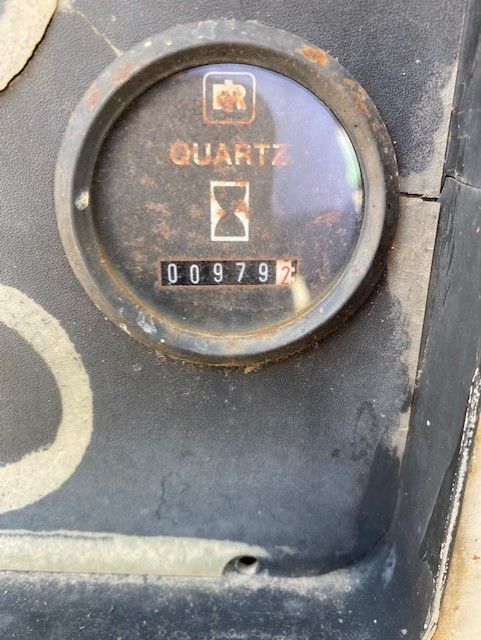 A close up of a clock that says quartz on it