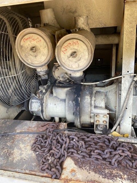 A close up of a machine with a fan and chains.