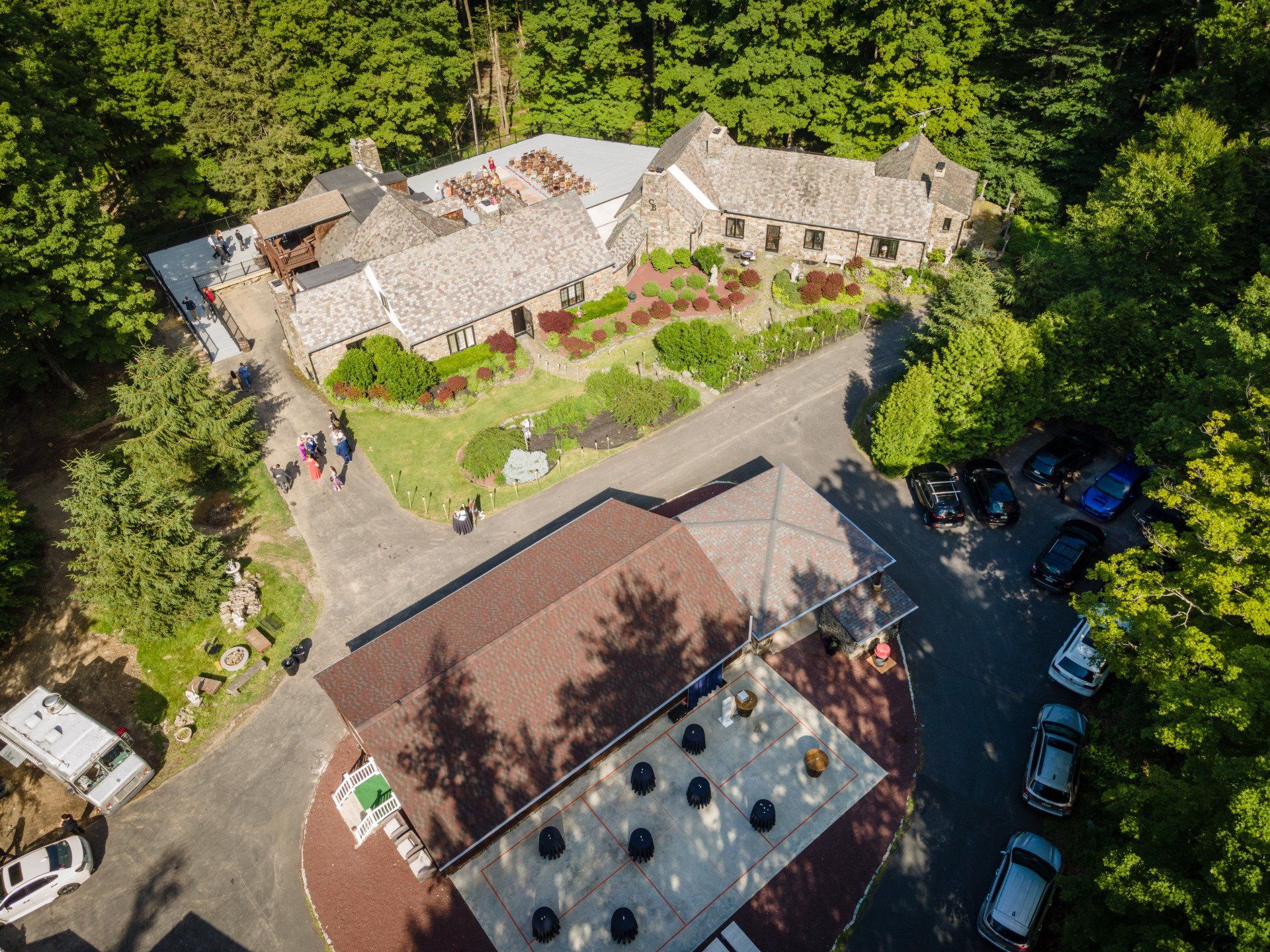An aerial view of a large house surrounded by trees.