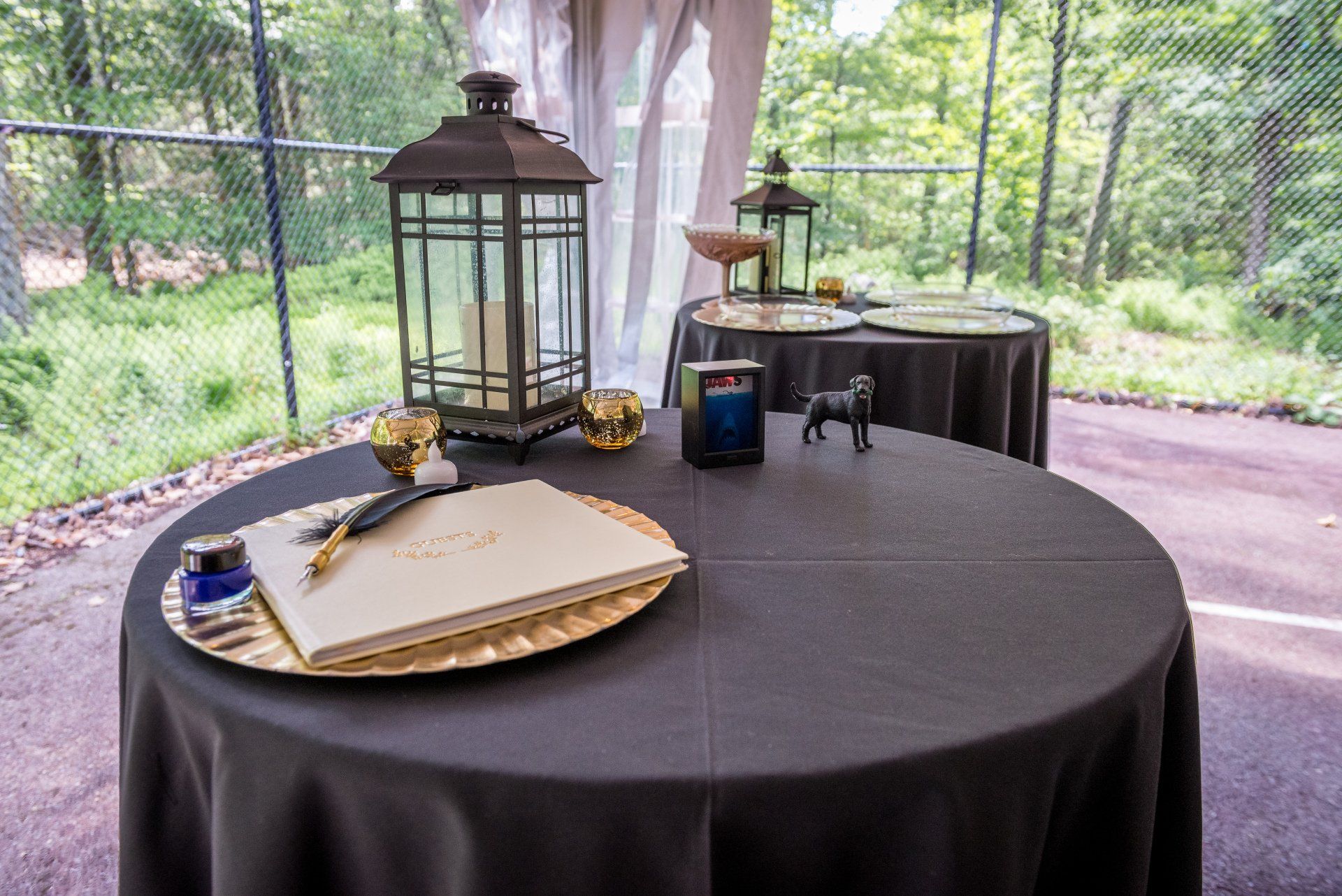 A table with a black table cloth and a book on it.