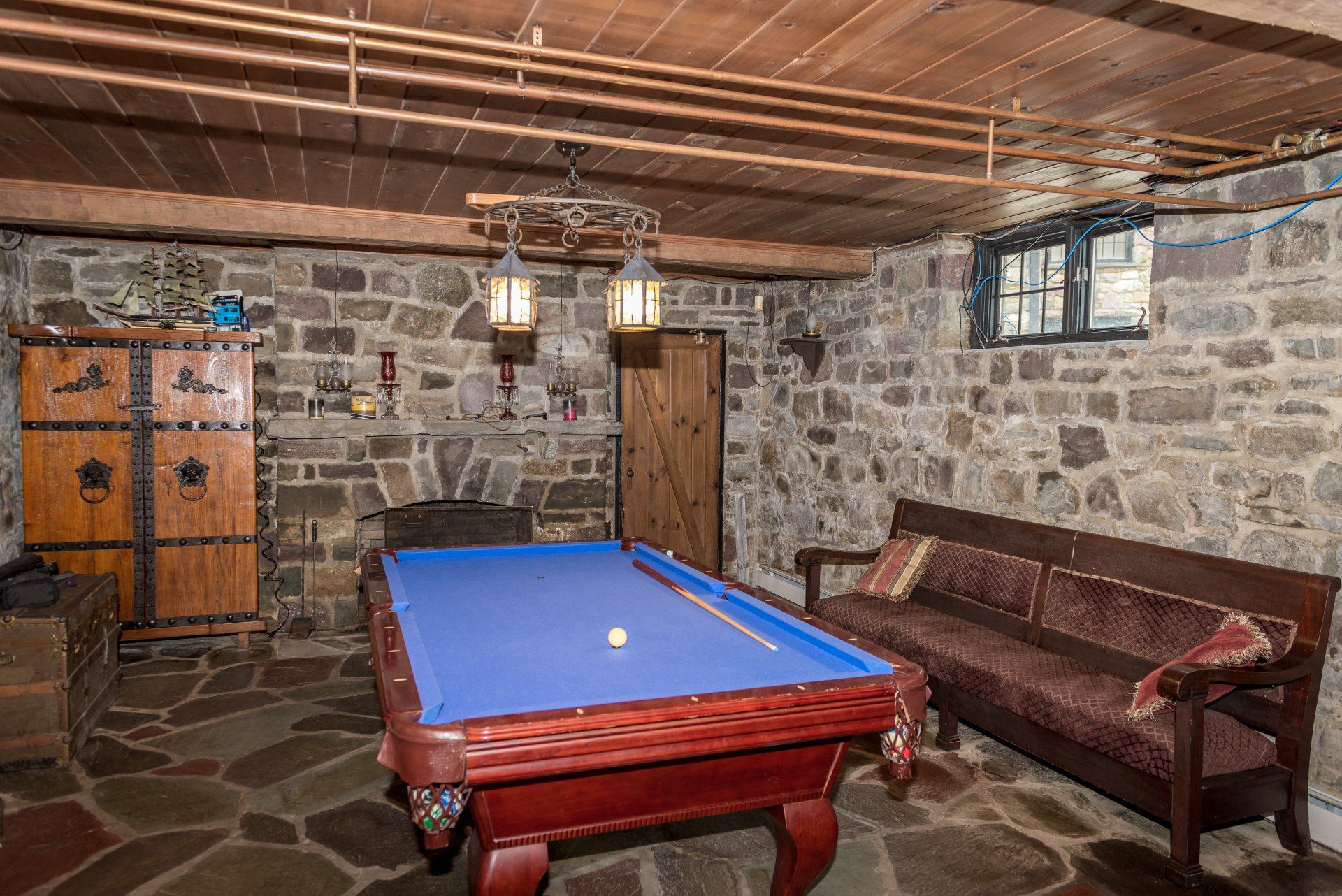 There is a pool table in the middle of the room.