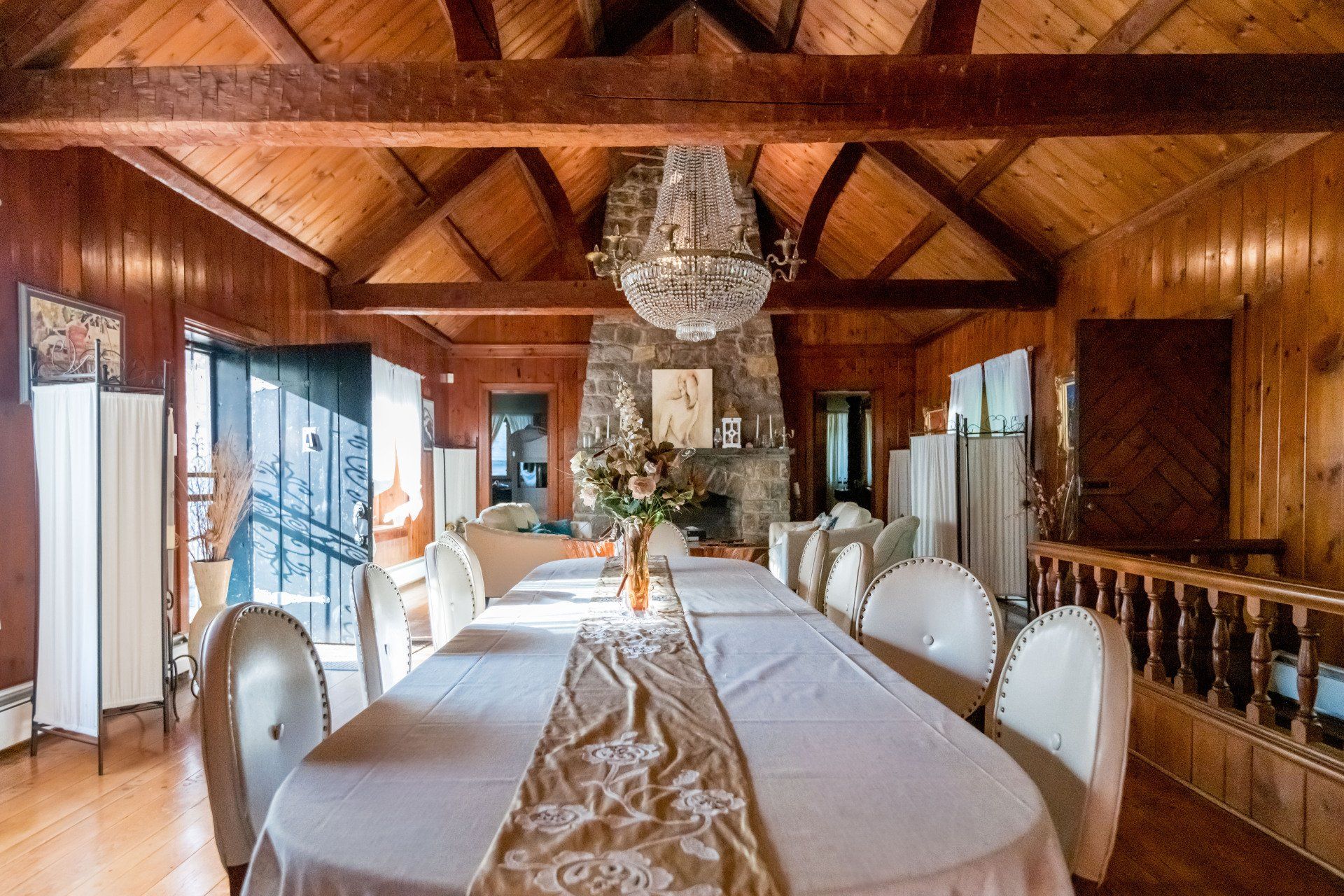 A large dining room with a long table and chairs
