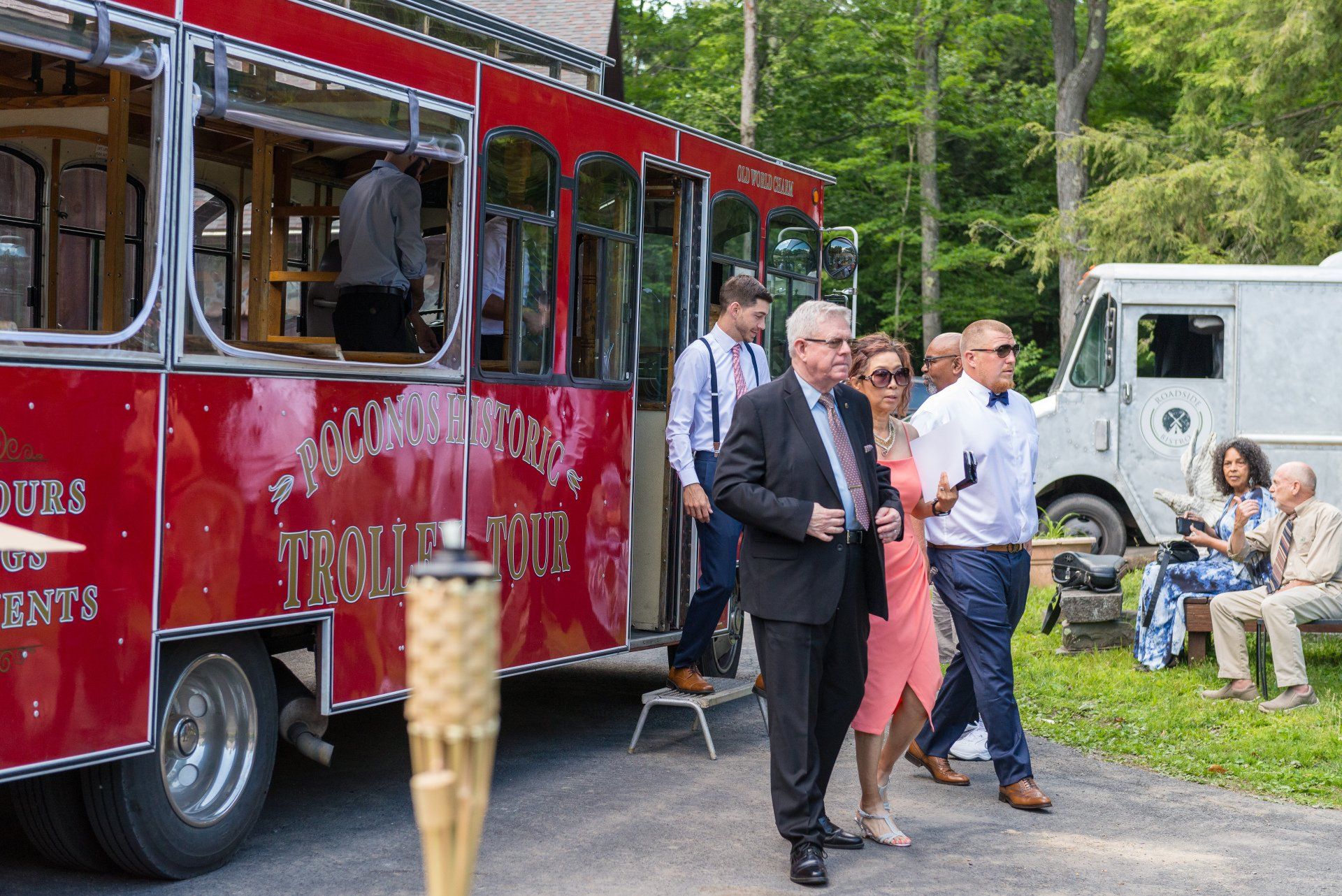 A group of people are walking towards a red food truck.