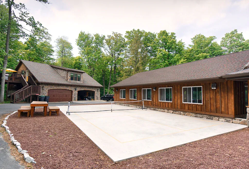 A large house with a picnic table in front of it