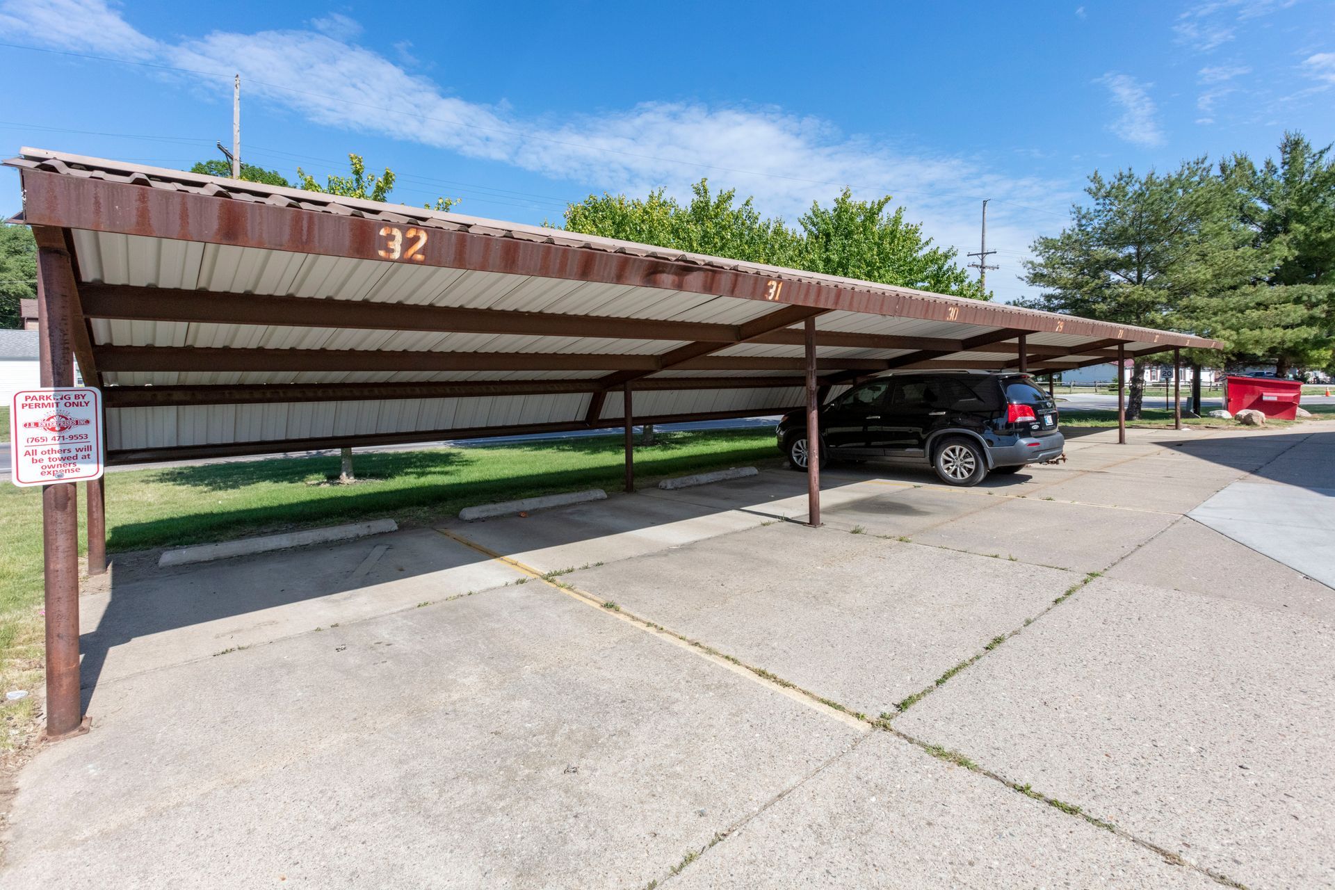 a car is parked under a covered parking lot .
