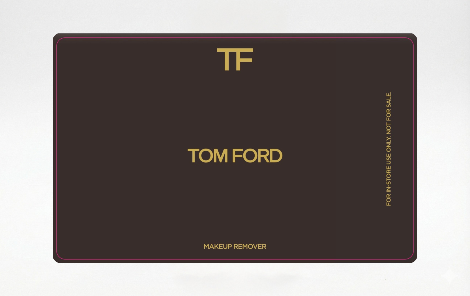 A dark brown Tom Ford gift card with gold 