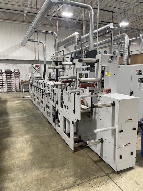 Large industrial printing machine in a warehouse setting.
