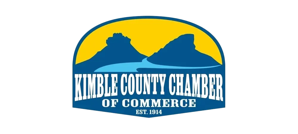 Kimble County Chamber of Commerce logo with mountains, blue water, and yellow sky.