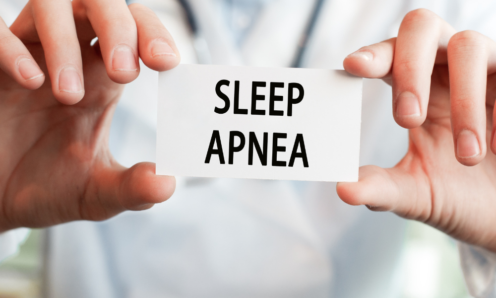 A doctor is holding a card that says sleep apnea.