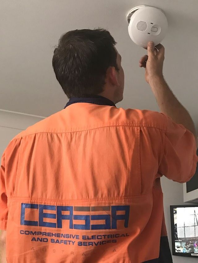 Technician Checking Fire Alarm — Electrical & Fire Safety Services in Salamander Bay, NSW