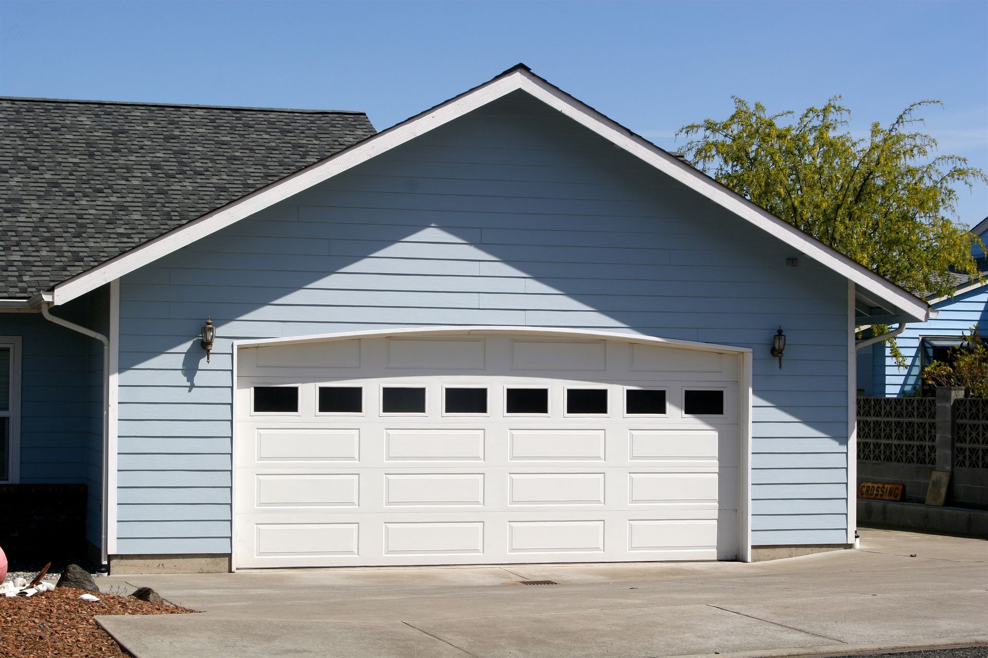 A blue house with a white garage door