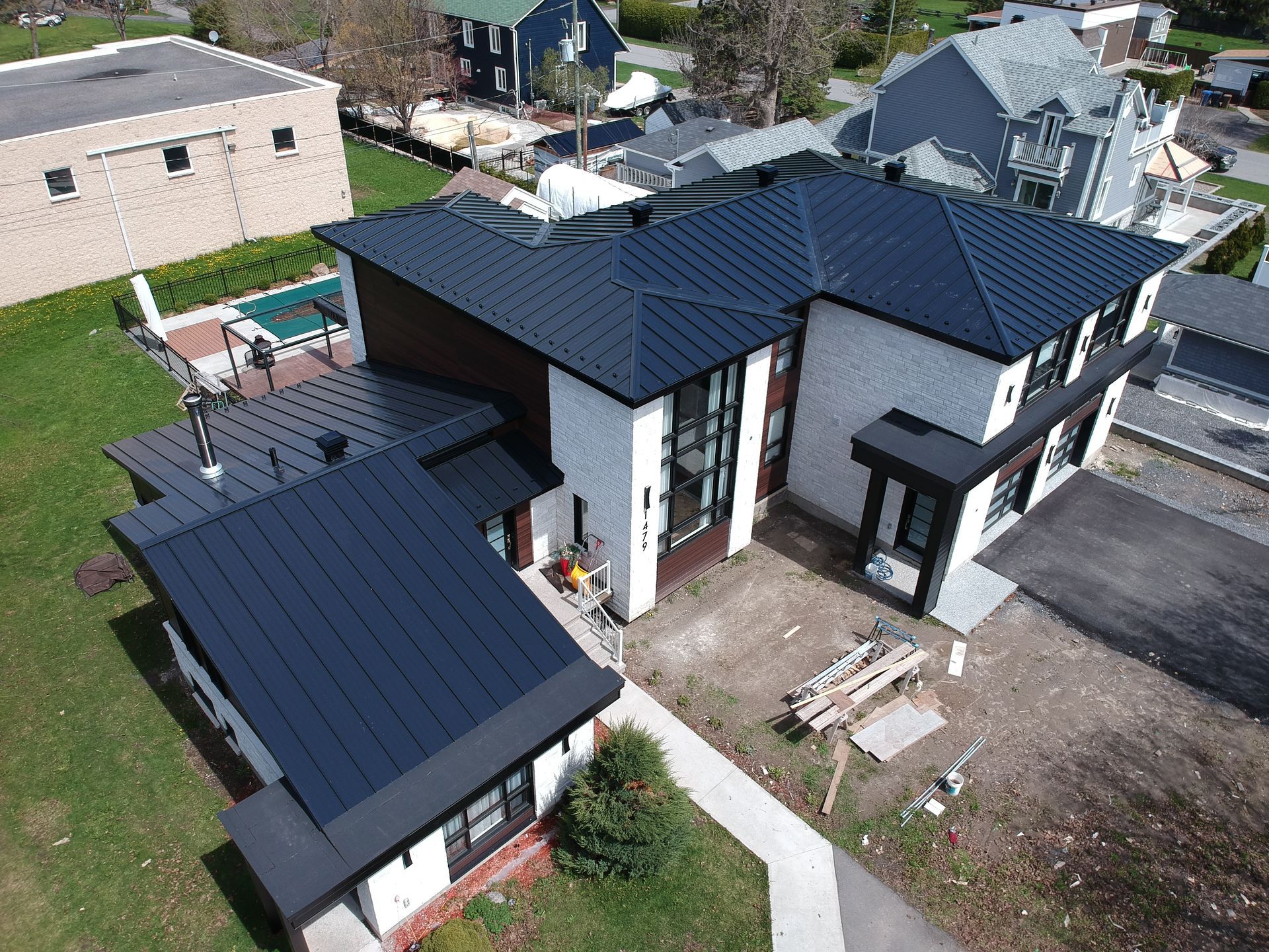Une vue aérienne d'une grande maison avec un toit noir.