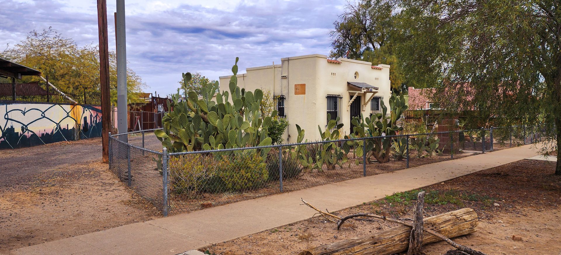 A wooden fence is sitting on top of a lush green lawn in front of a house.