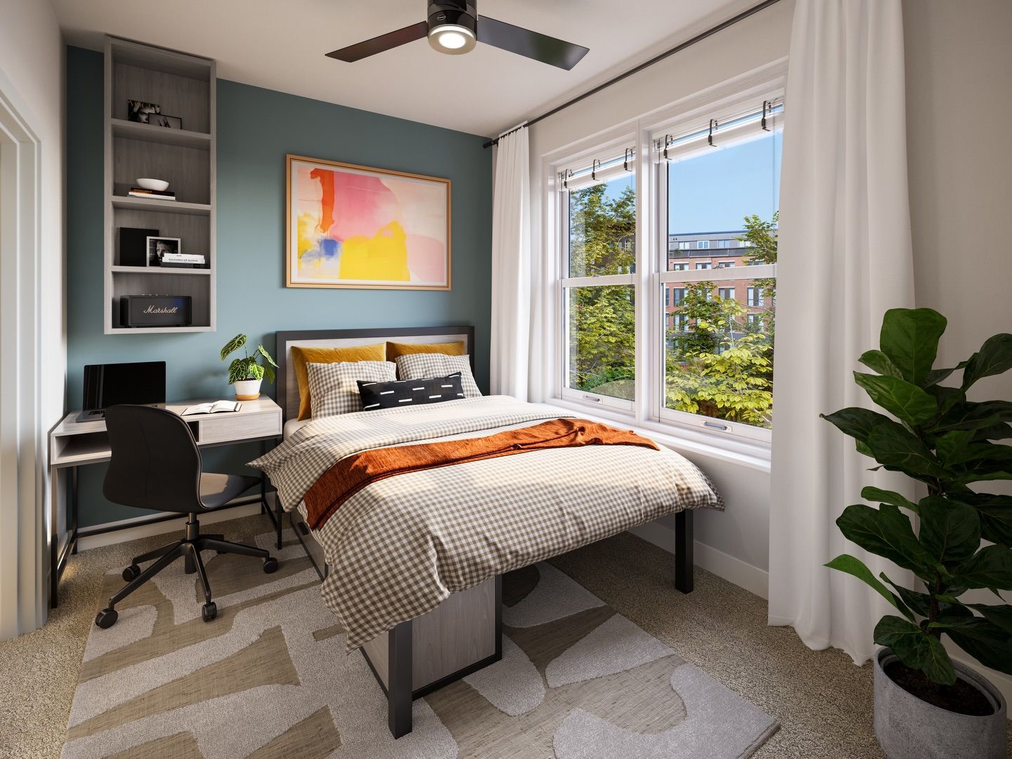 A modern bedroom with a blue accent wall, a desk, a patterned bed, a ceiling fan, and a potted plant by a window.