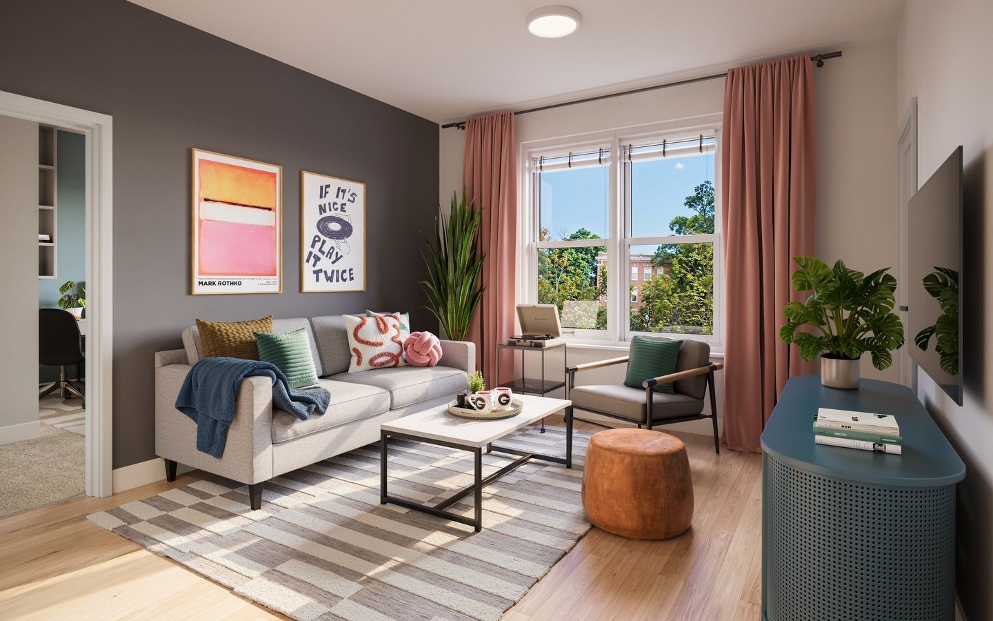 A modern living room with a grey accent wall, light grey sofa, striped rug, teal console table, and dusty pink curtains.