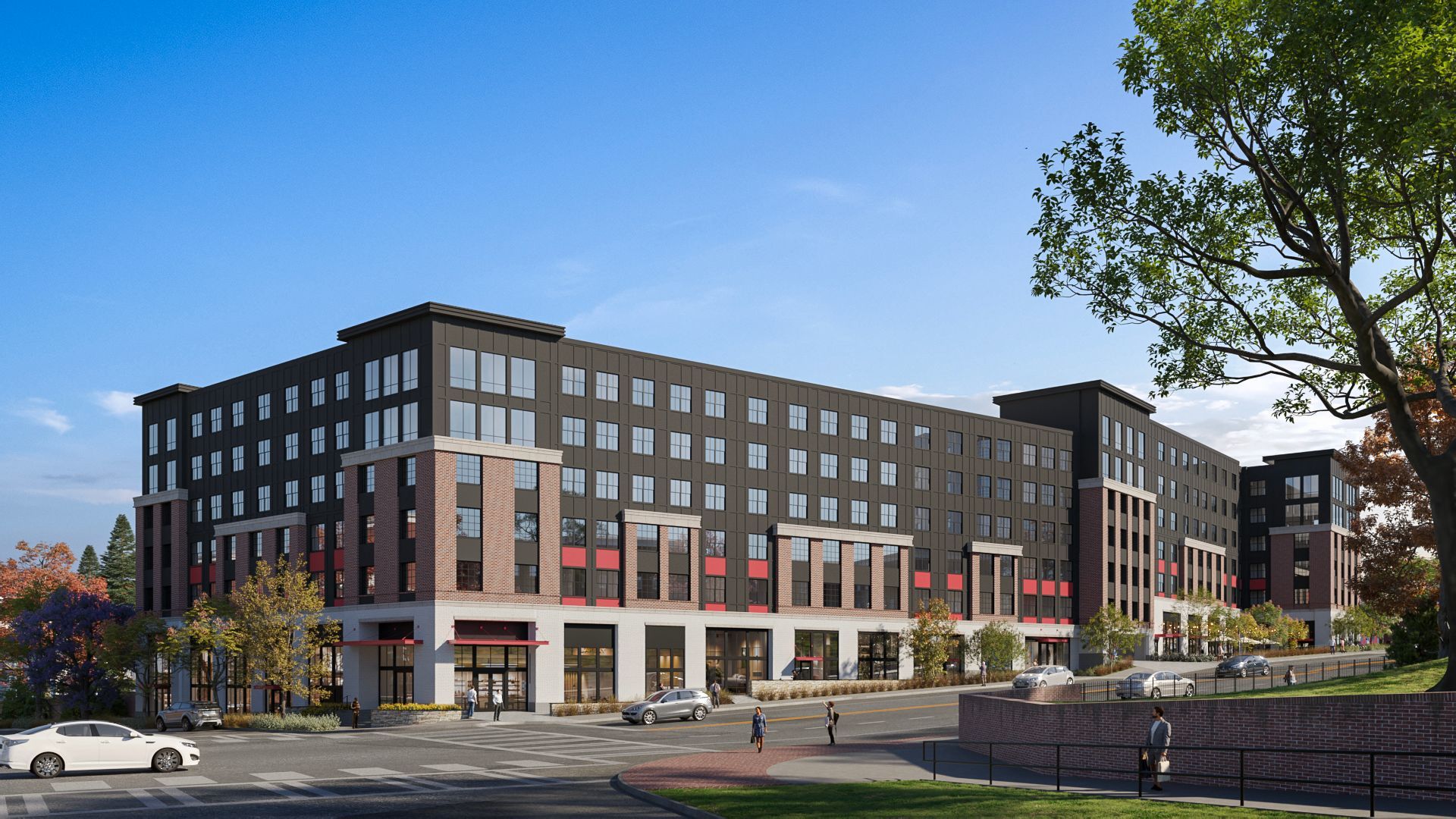 Modern multi-story apartment building with retail on ground level, clear sky.