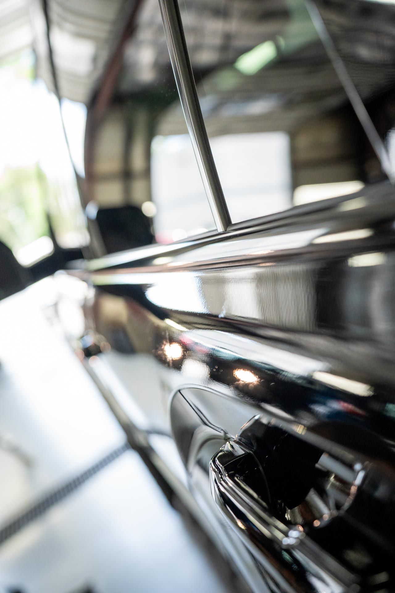 A close up of a car door in a garage.