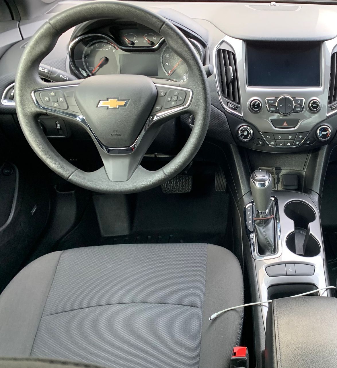 The interior of a chevrolet cruze with a steering wheel and seats.
