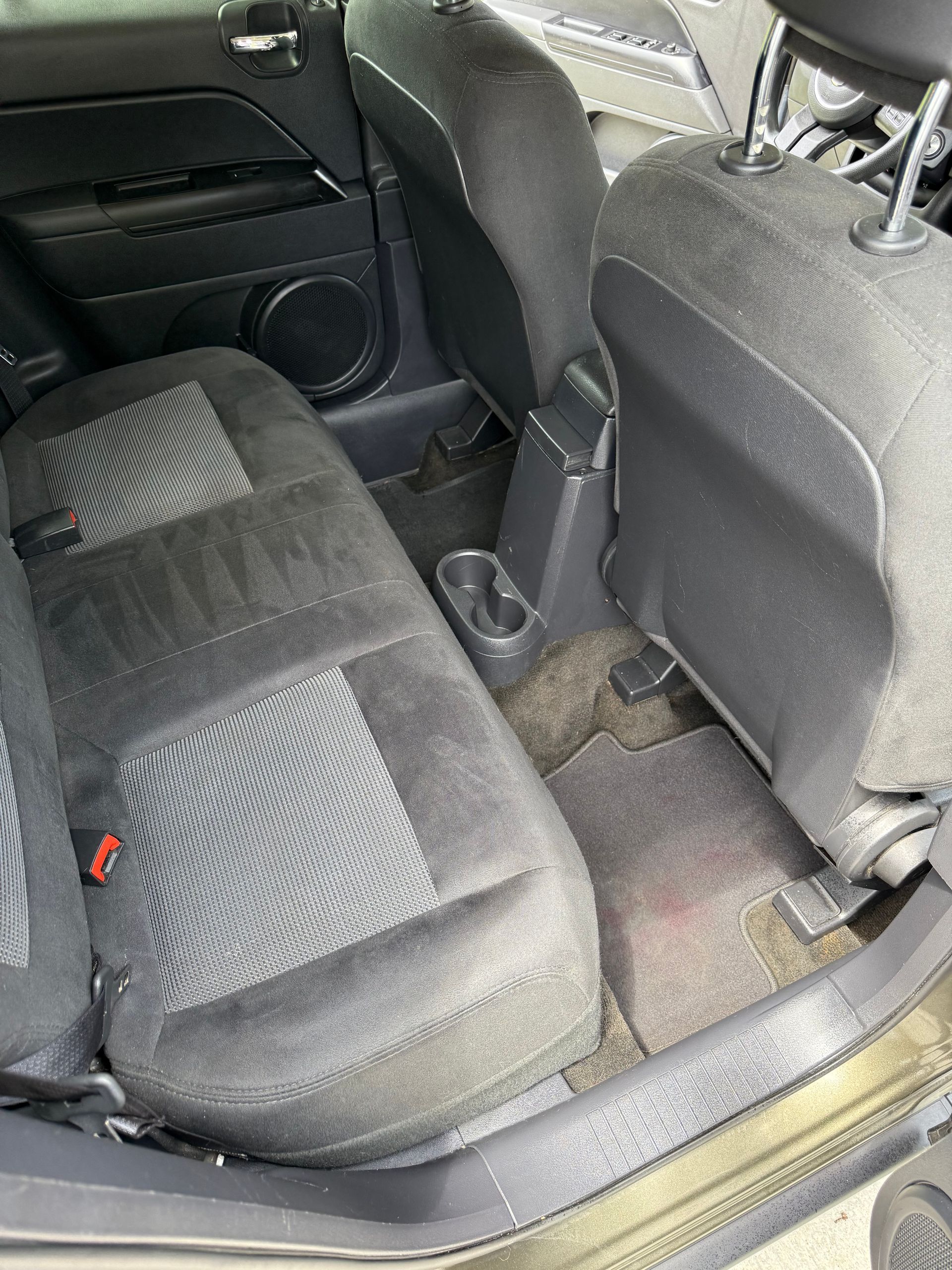 A car with a carpeted floor and a brake pedal