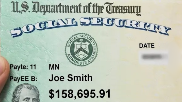 A man and a woman are looking at a tablet in an office.