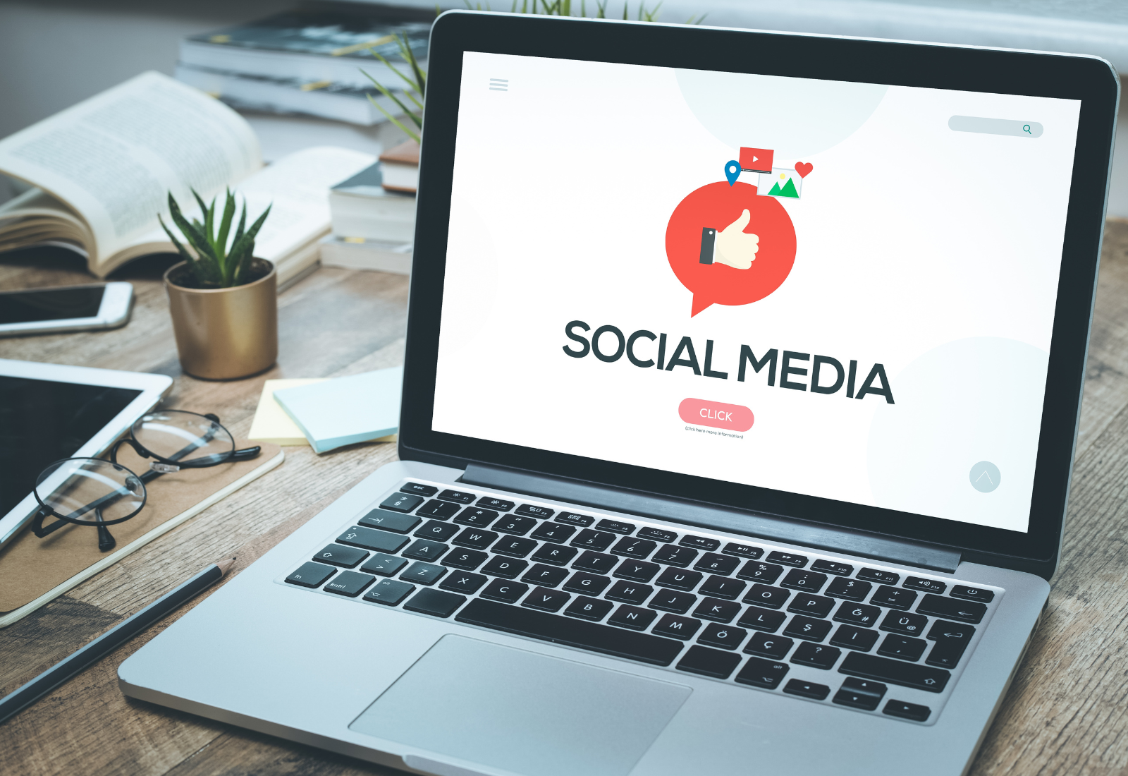 A laptop showing a social media concept on the screen