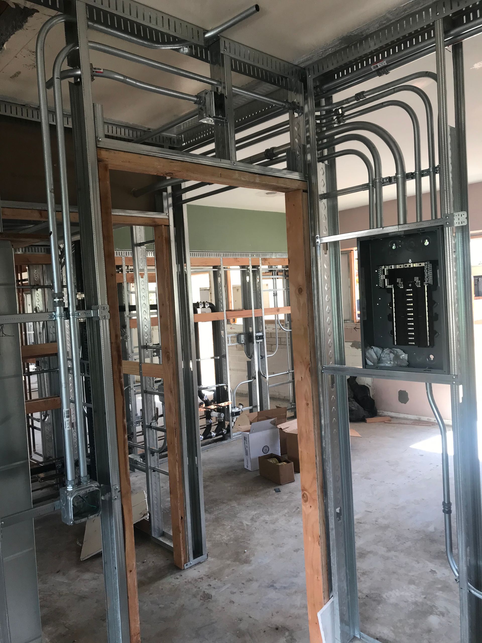 A building under construction with a lot of wires coming out of it.