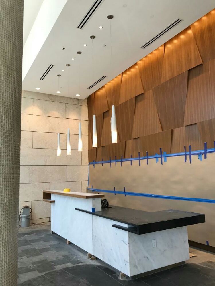 An empty lobby with a counter and a wooden wall