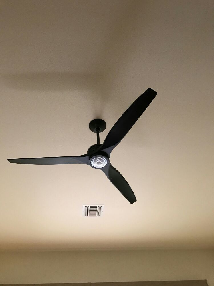 A ceiling fan is hanging from the ceiling of a room.