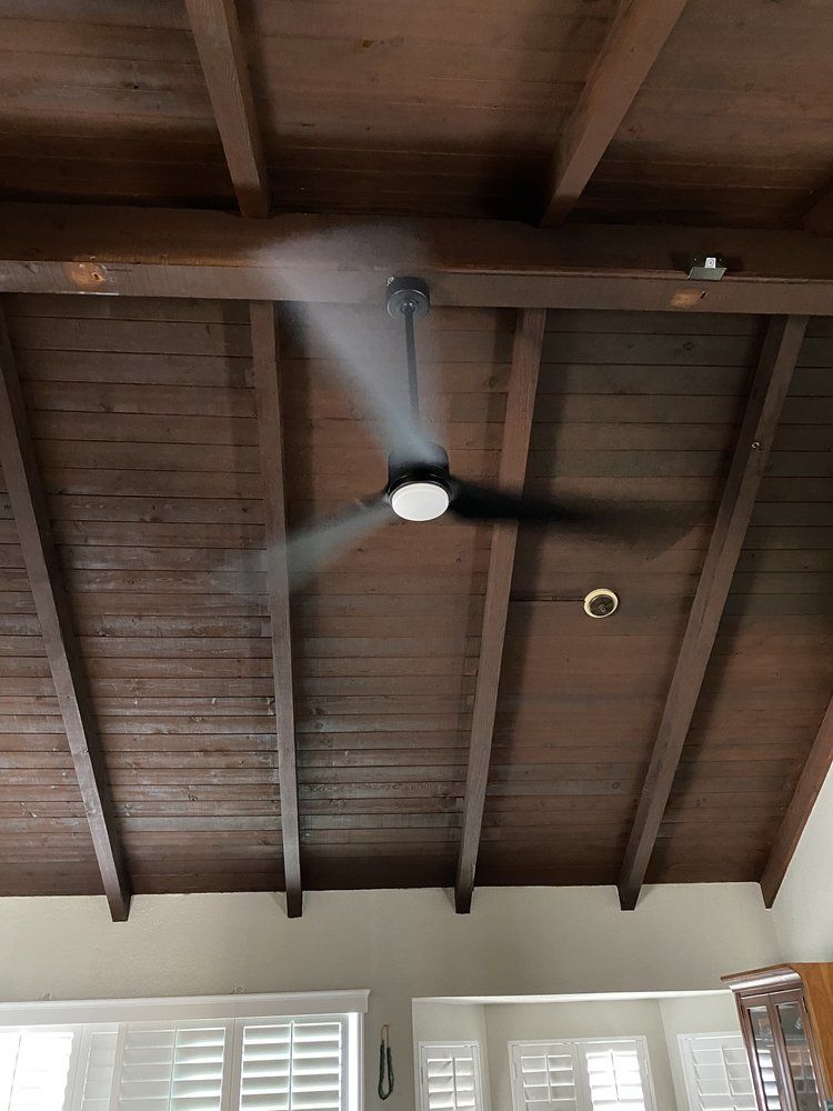 A ceiling fan is hanging from the ceiling of a room.