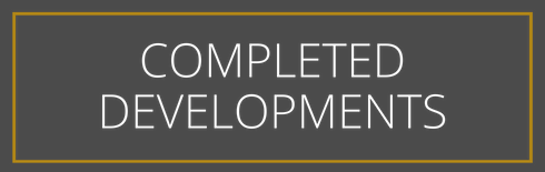 A sign that says `` completed developments '' on a gray background.