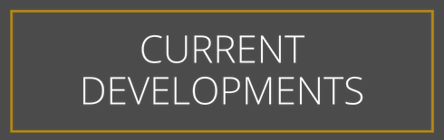 A sign that says `` current developments '' on a gray background.