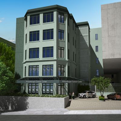 A light green multi-story building labeled 