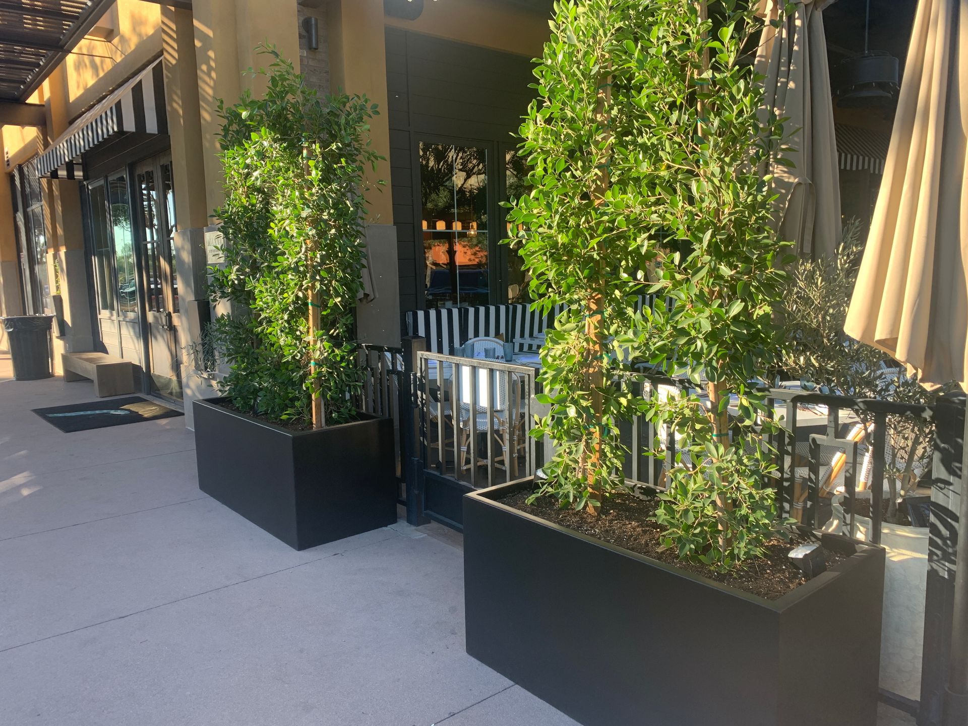 Pile of blue ceramic flower pots against a white wall.