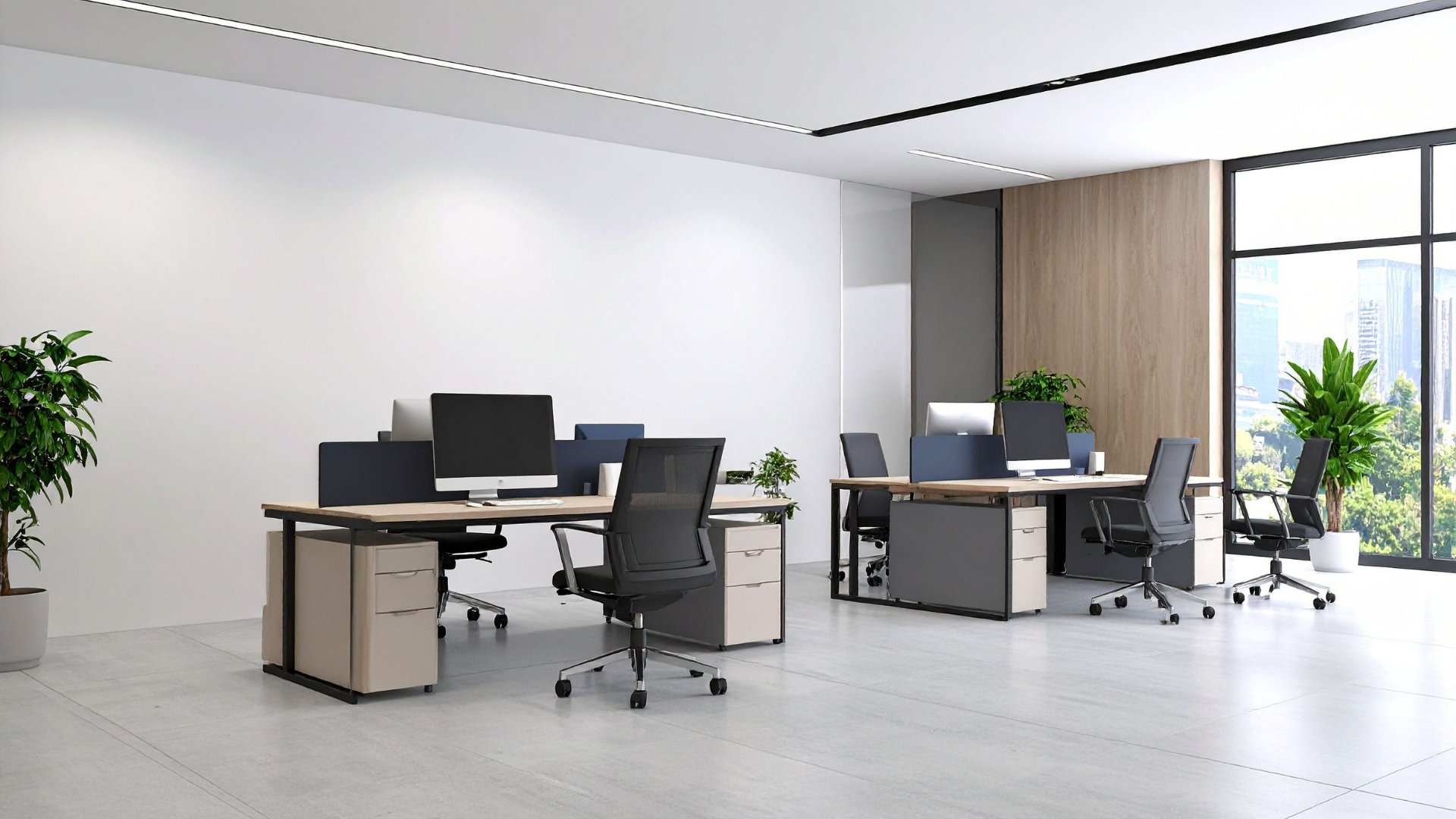 Modern office with desks, chairs, and monitors; plants, natural light, and neutral tones.