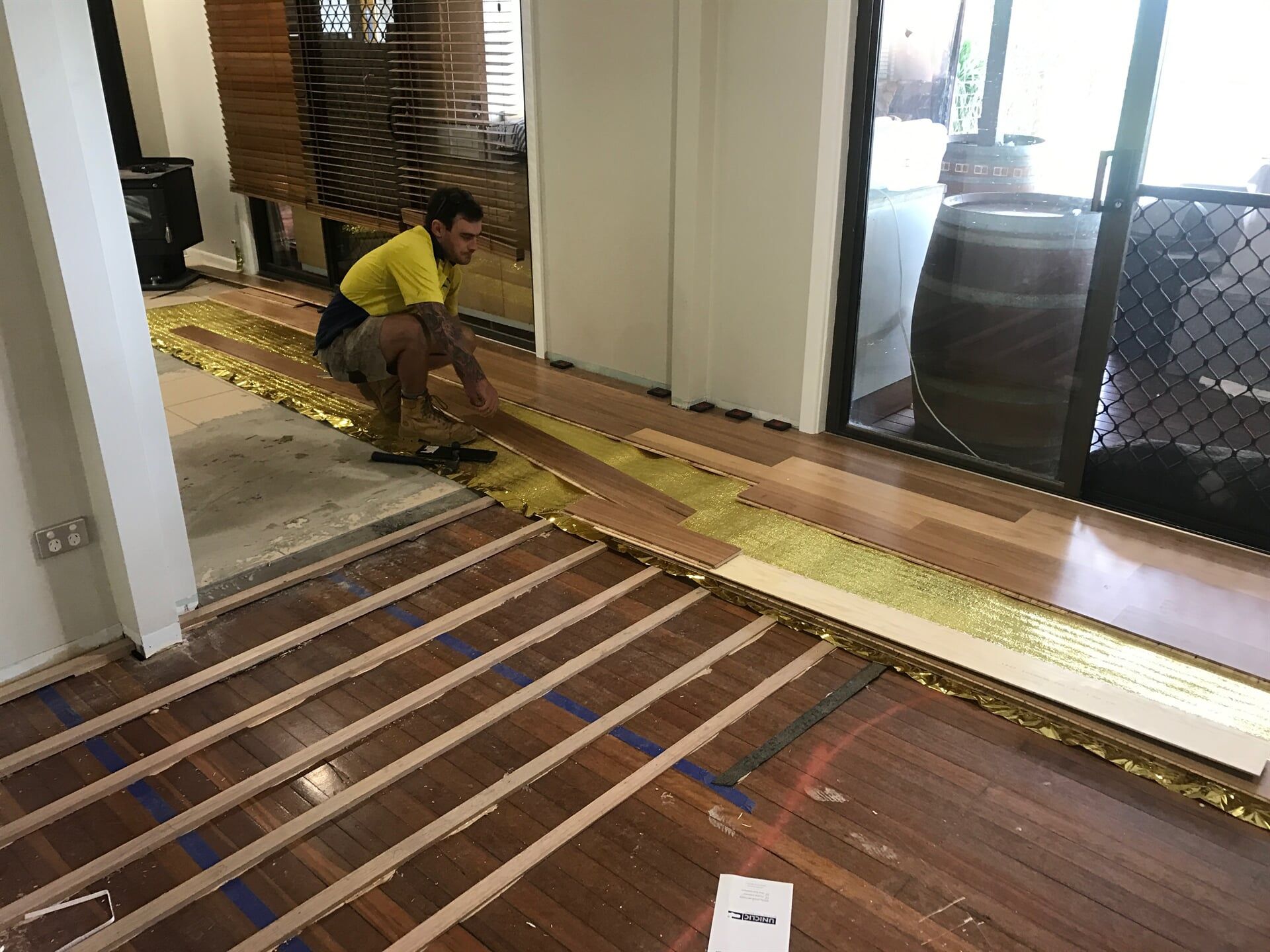 Man Covering the Old Floor with New Floorboard — Pacific Flooring in Bonville, NSW