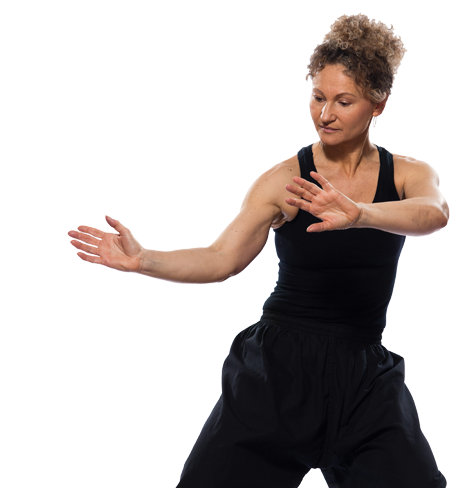 A woman in a black tank top and black shorts is dancing