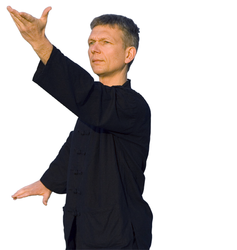 A man in a black shirt is raising his arm in the air