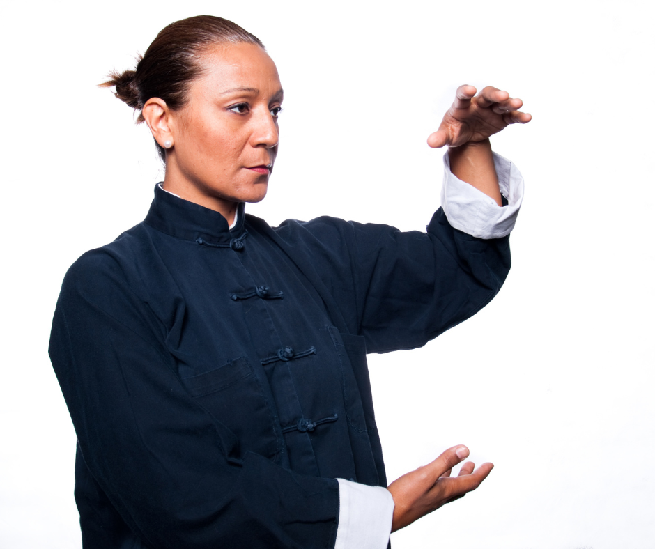 A woman in a black jacket is practicing martial arts