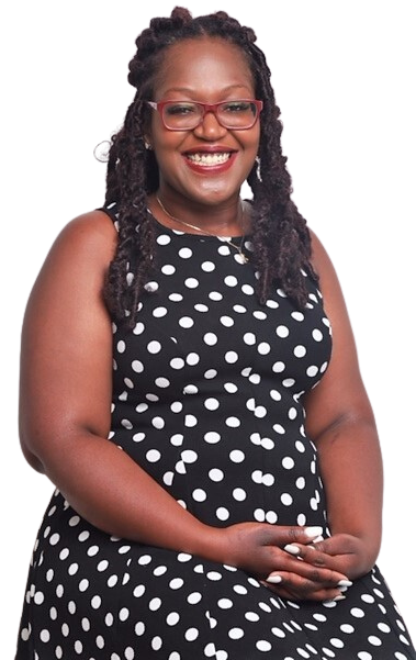 Woman in polka dot dress, smiling, wearing glasses.