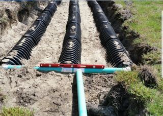Septic System Flush — Septic Servicing Truck Working in Urban Place in Elmendorf, TX