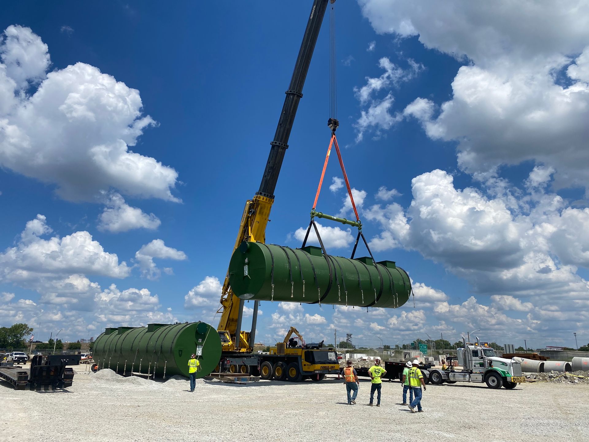 A man is driving a forklift on a city street.