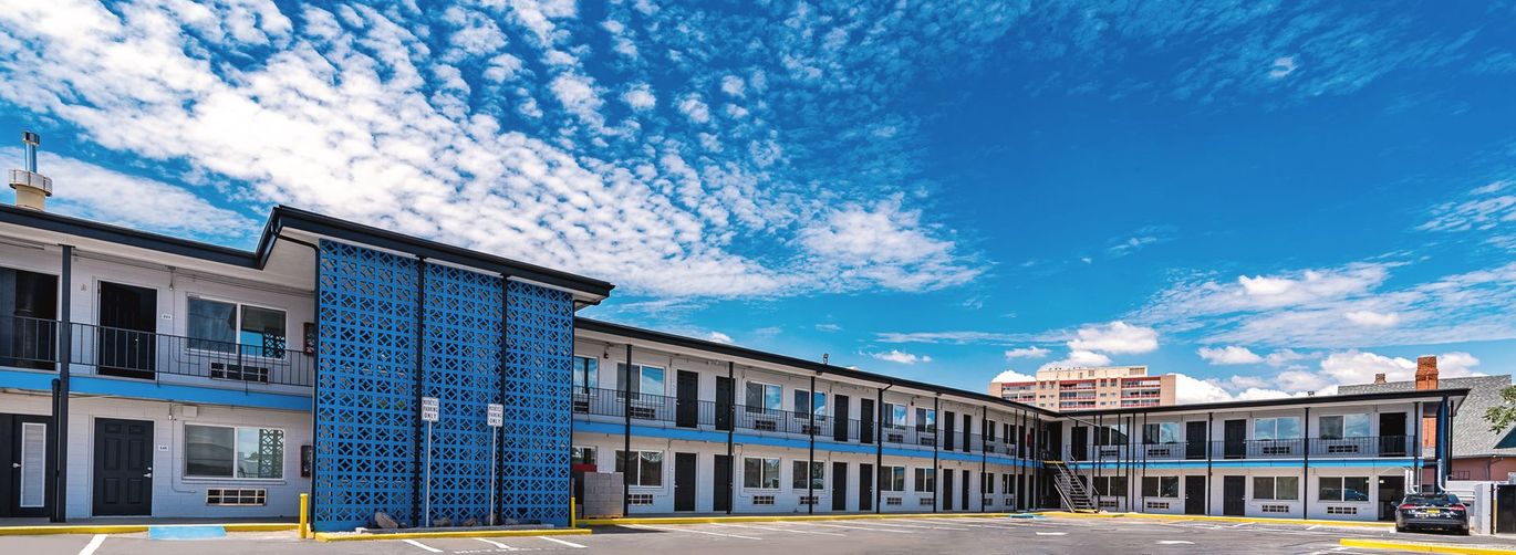 A large blue and white building with a blue sky in the background.