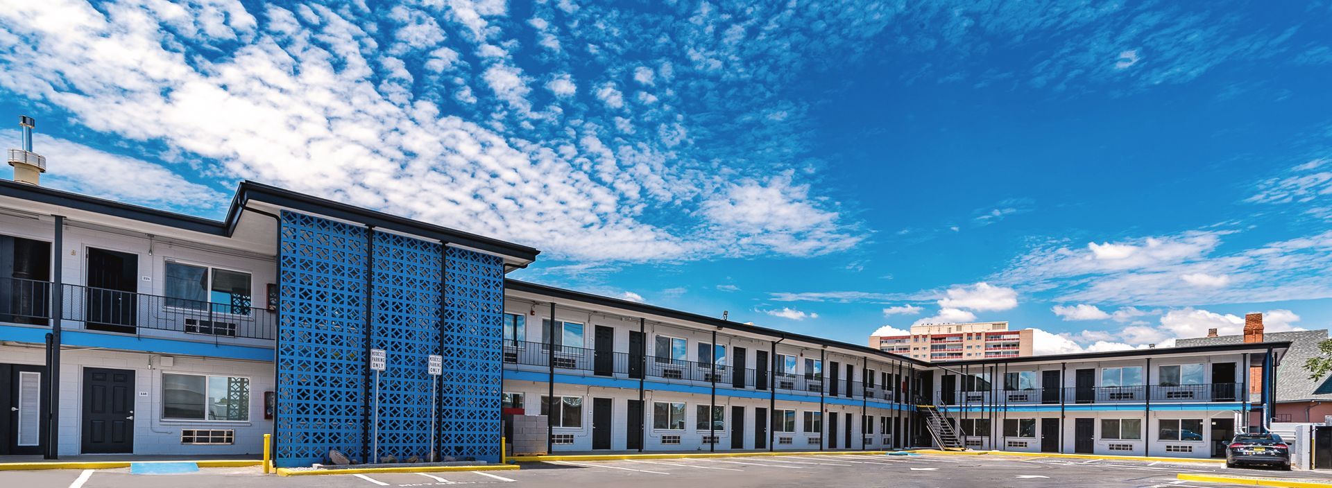 A large blue and white building with a blue sky in the background.