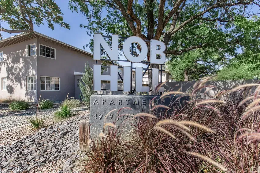 A building with a sign that says nob hill apartment