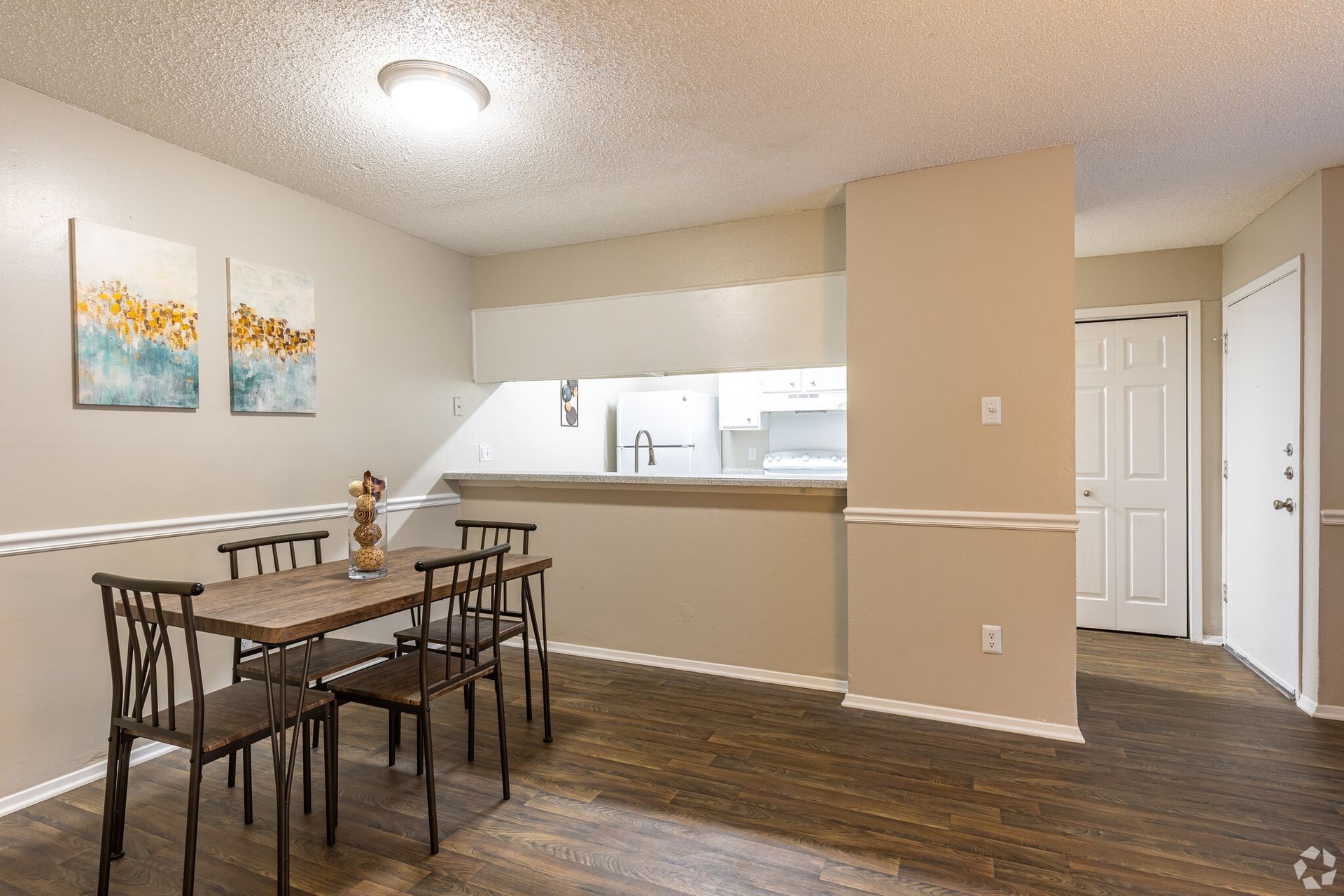 A dining room with a table and chairs in a house.