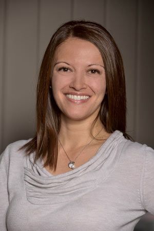 A woman is leaning on a speedvall counter
