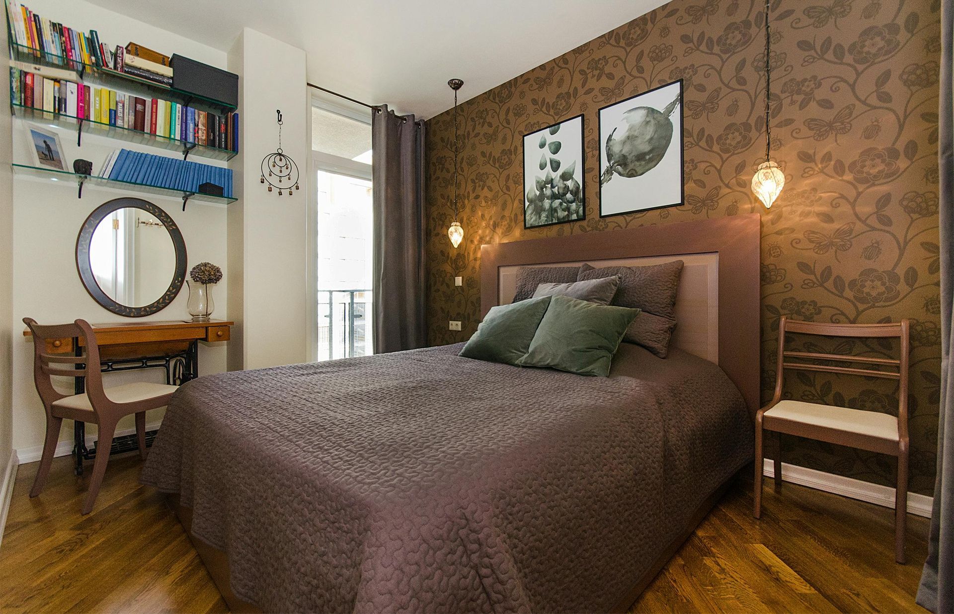 A bedroom with a large bed , chairs , a desk and a mirror.