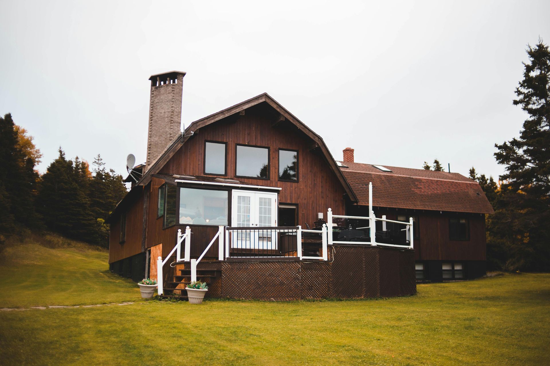 A white house with a wooden deck in front of it