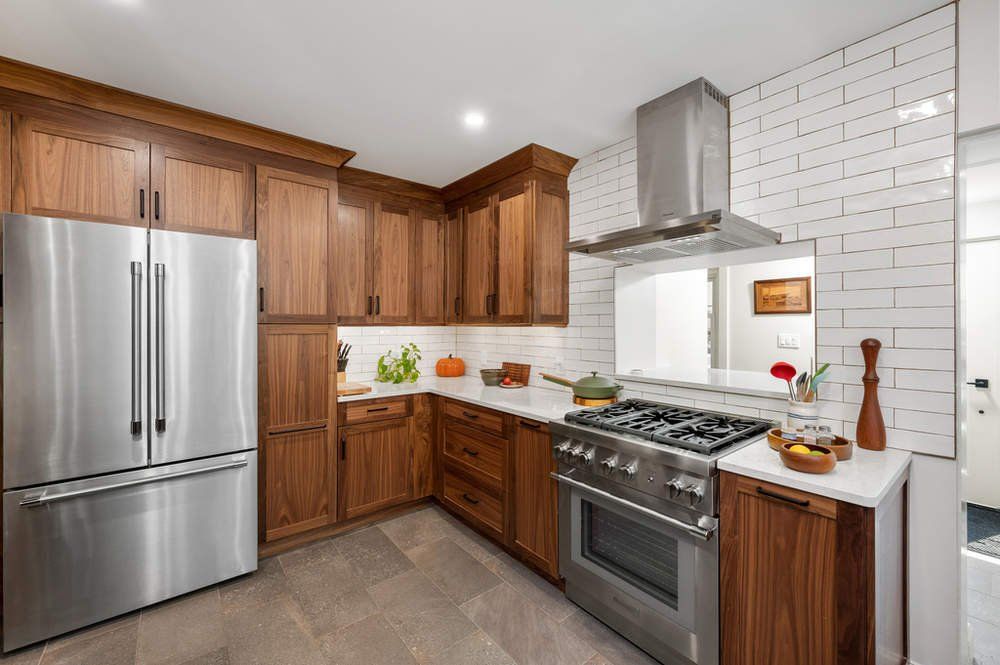 A kitchen with stainless steel appliances and wooden cabinets.