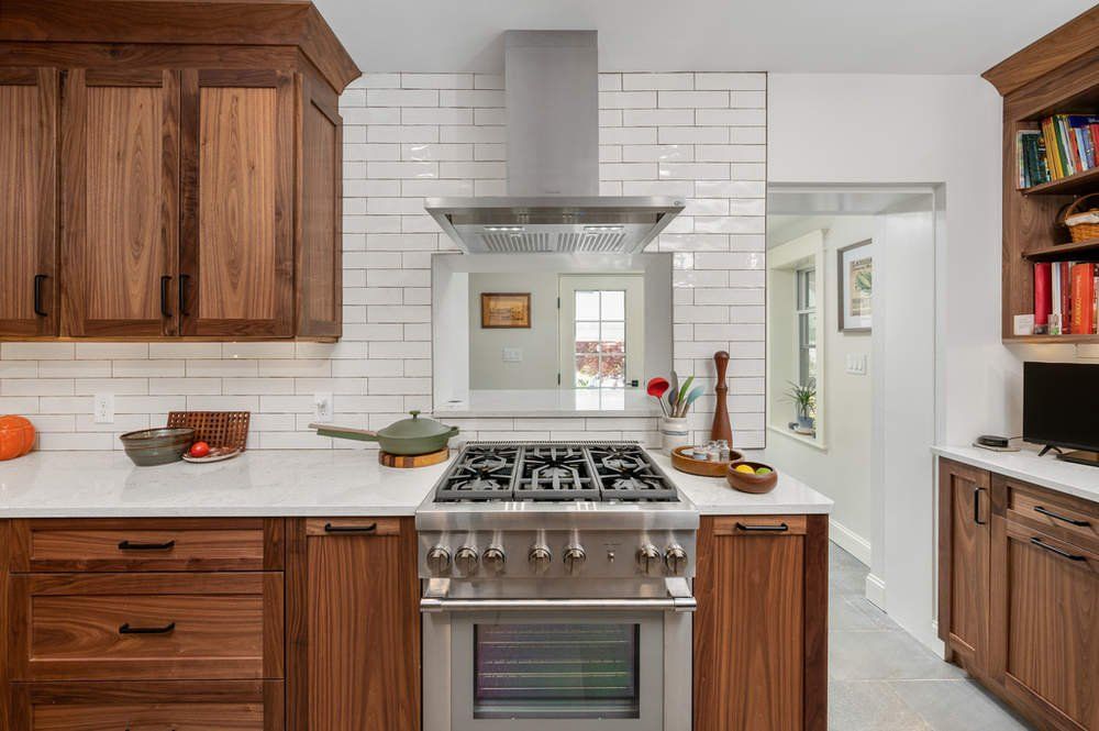 A kitchen with stainless steel appliances and wooden cabinets.